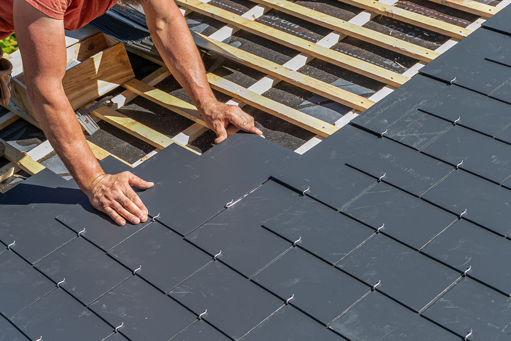 Craftsman,Is,Installing,A,Slate,Roof.,Professional,Roof,Workers,Installing Roof contractor is installing a slate roof for a house in Kansas city