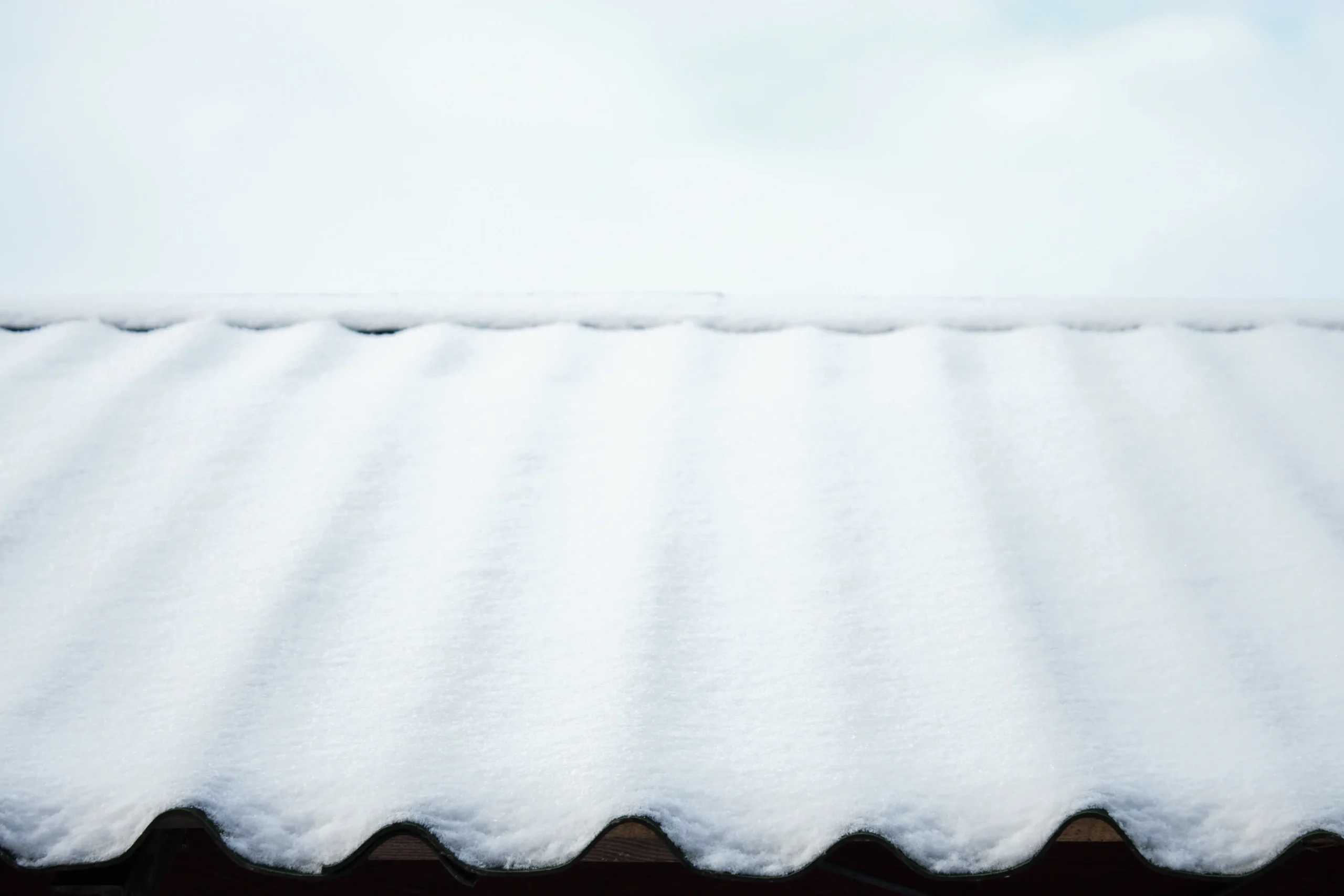 Winter sky and roof covered with snow.